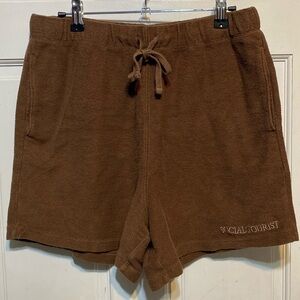 Medium Social Tourist(Hollister) brown shorts with pockets and a tie waist band.
